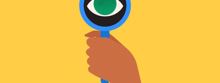 A banner image showing a hand holding a blue magnifying glass with an eye where the lens would normally be.